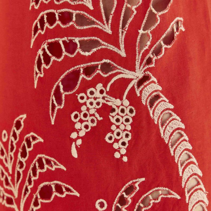 Detalle-de-los-bordados-botanicos-en-el-pantalon-rojo-mostrando-el-diseño-intrincado.