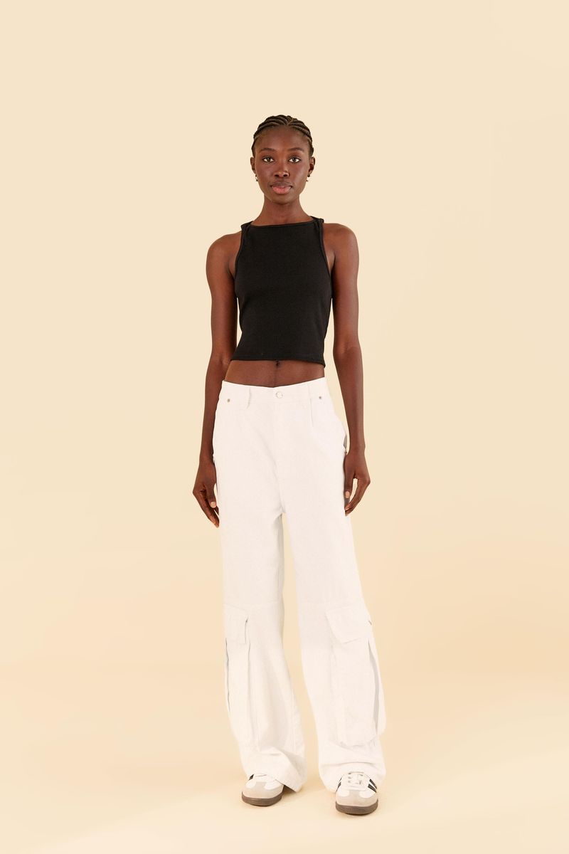 Modelo-usando-pantalon-cargo-blanco-en-sarga-con-un-top-negro-sin-mangas-vista-frontal.