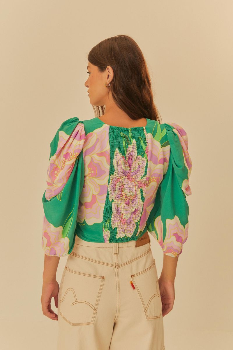 Vista trasera de la blusa Lastex Floral Lumi mostrando el detalle lastex y el estampado floral.