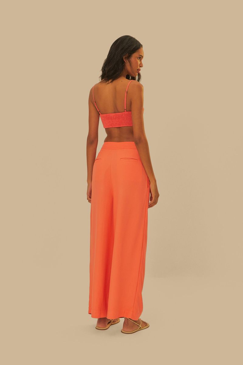 Vista-completa-del-pantalon-recto-naranja-con-pinzas-combinado-con-sandalias.