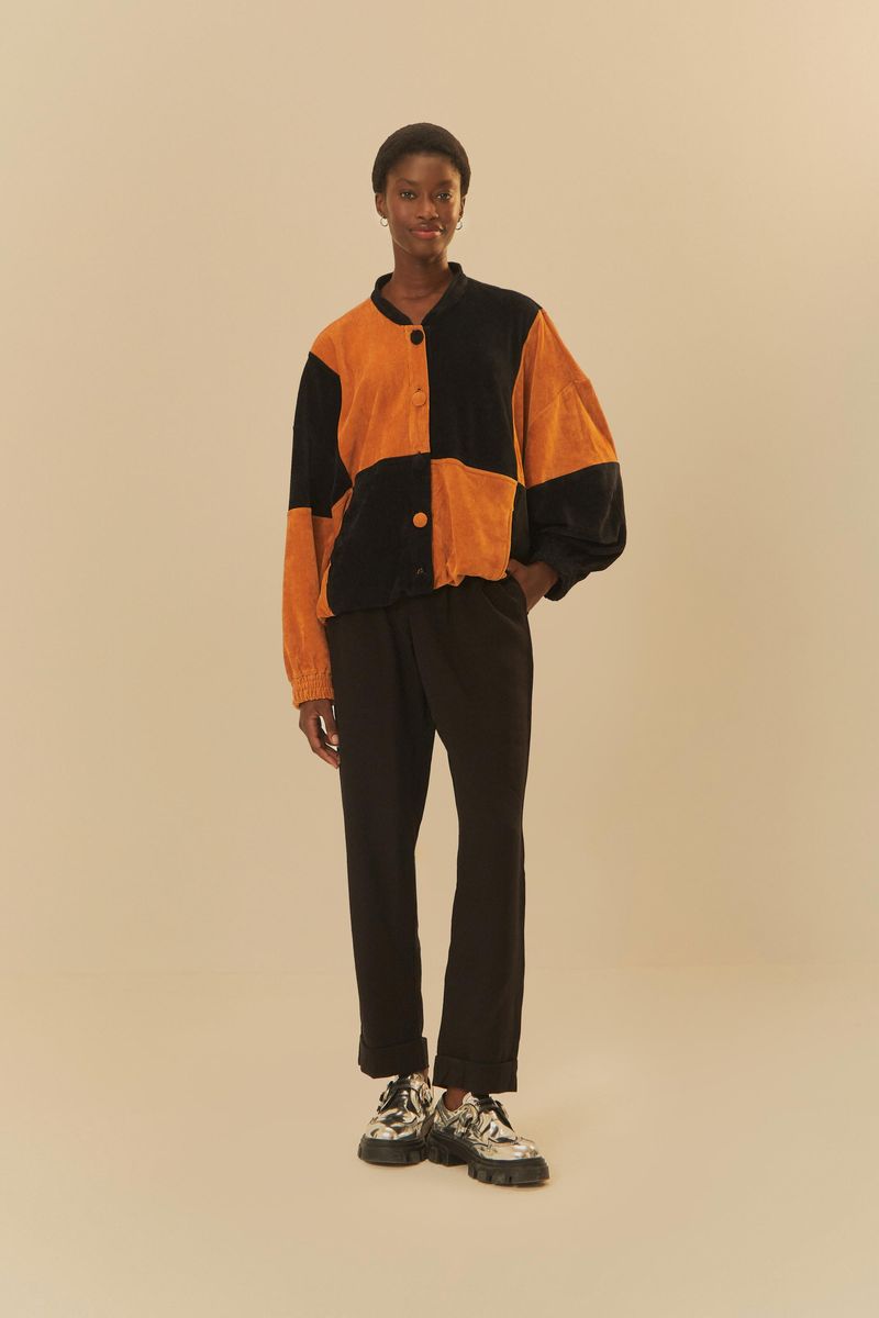 Modelo-luciendo-un-pantalon-negro-largo-con-cintura-alta-y-ajuste-recto-combinado-con-una-chaqueta-geometrica.