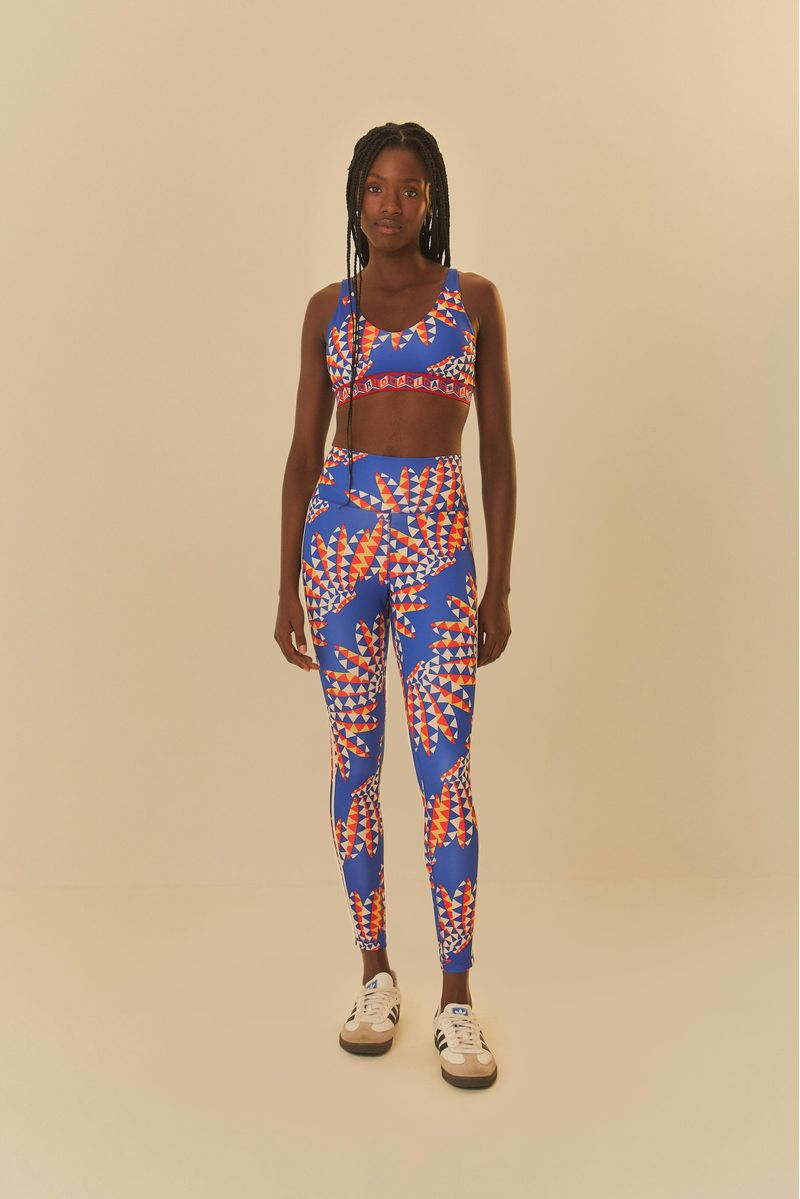 Conjunto deportivo Adidas con top y pantalón estampados, modelo en pose completa.
