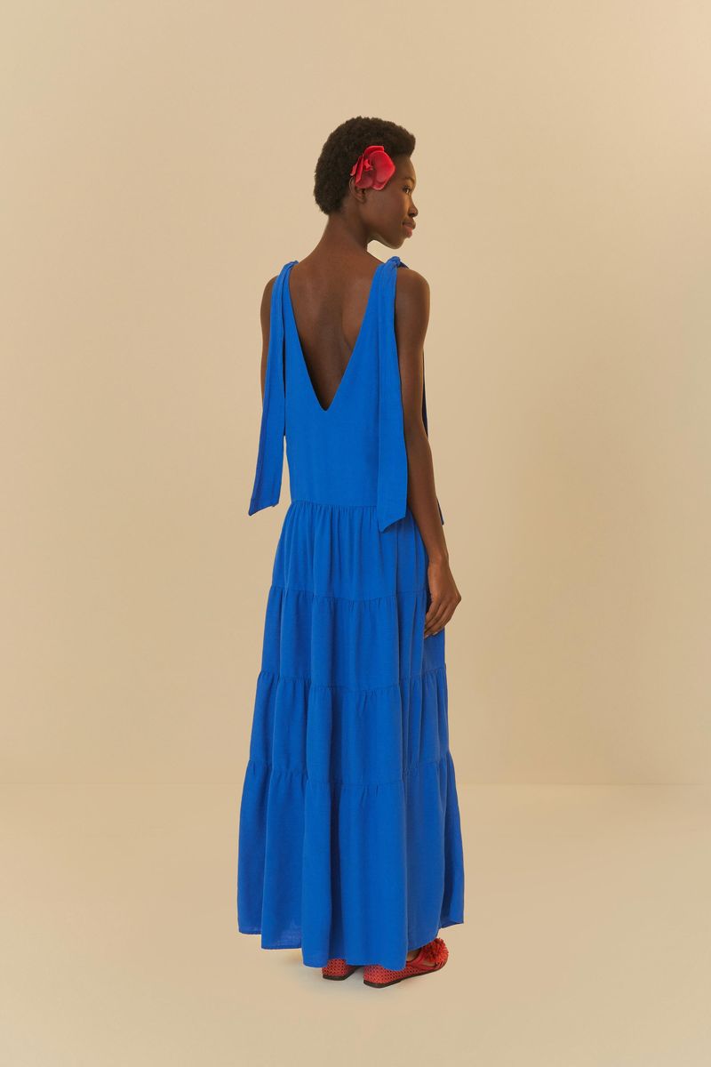 Close up del escote en V del vestido azul largo con tirantes delgados ajustables.