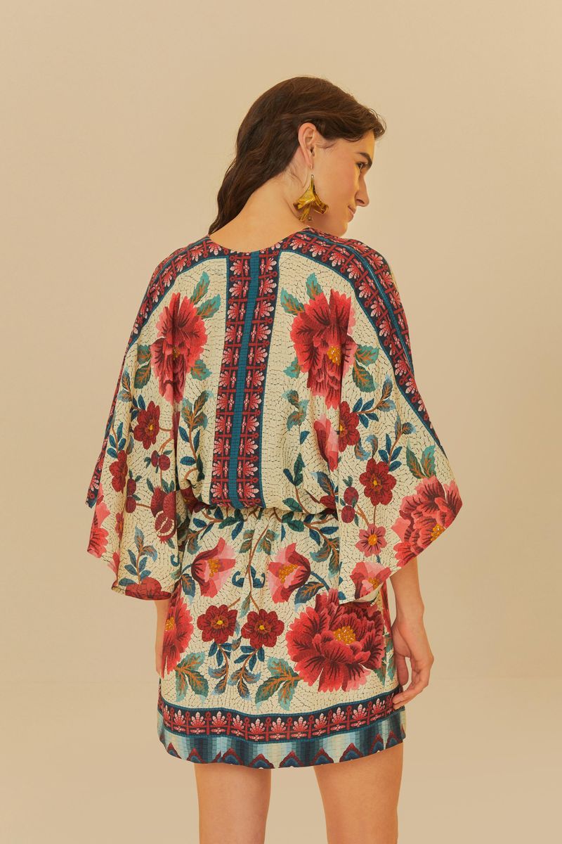 Vista trasera del vestido corto con estampado de flores en mosaico, destacando el diseño de la espalda.