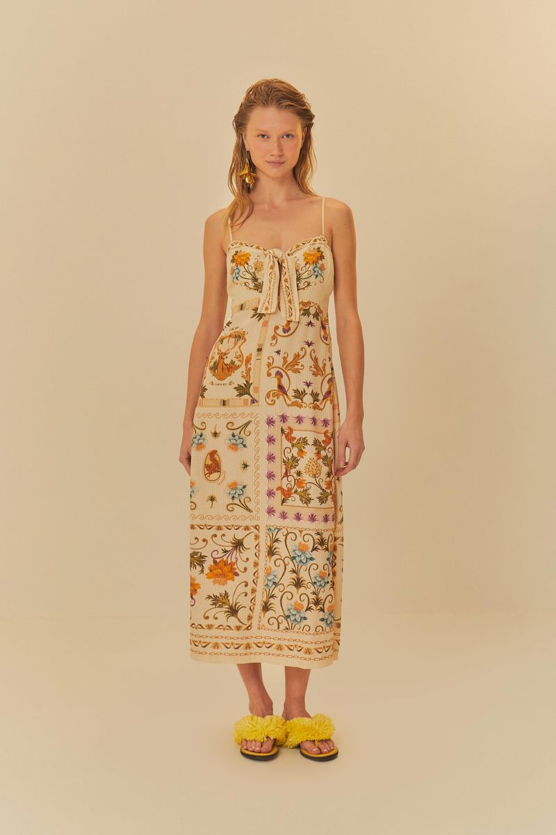 Vestido-midi-con-estampado-vibrante-tirantes-finos-y-detalle-de-lazo-combinado-con-sandalias-amarillas.