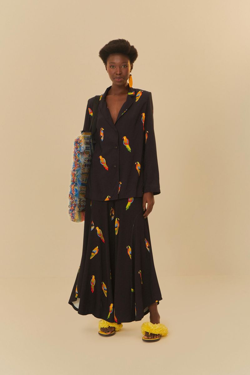 Modelo-luciendo-conjunto-de-pantalon-tipo-palazzo-y-blazer-negro-con-estampado-de-pajaros-coloridos.