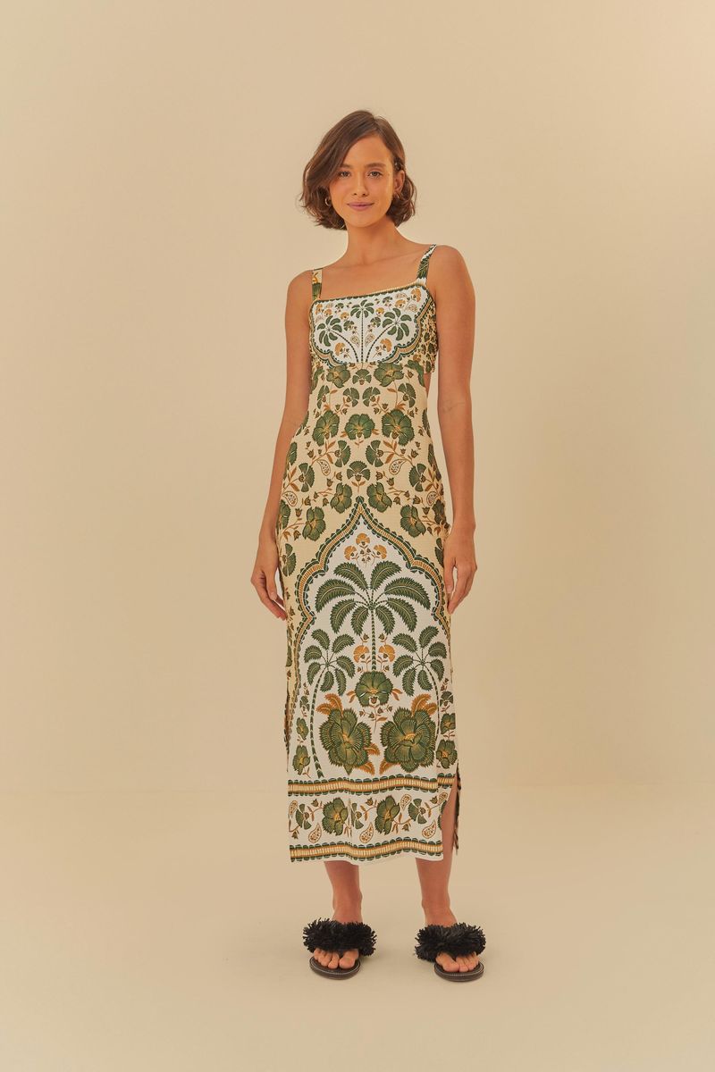 Vestido midi con estampado botánico en tonos verdes y detalles florales, visto de espaldas.