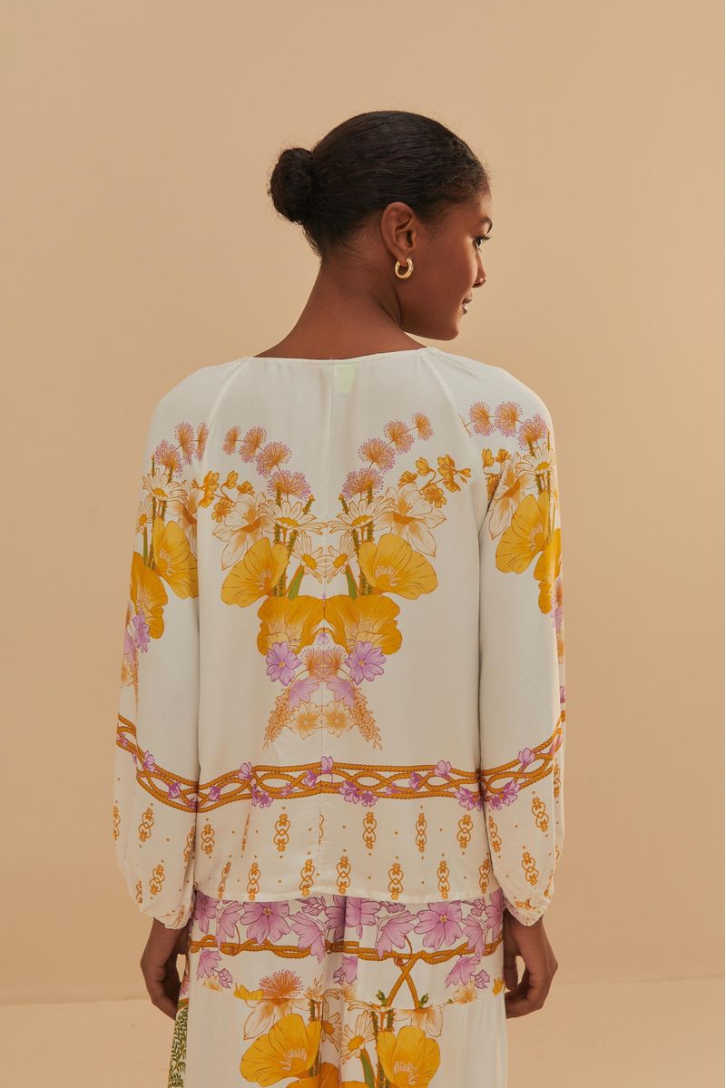 Vista trasera de la blusa Alice Off mostrando el estampado floral.