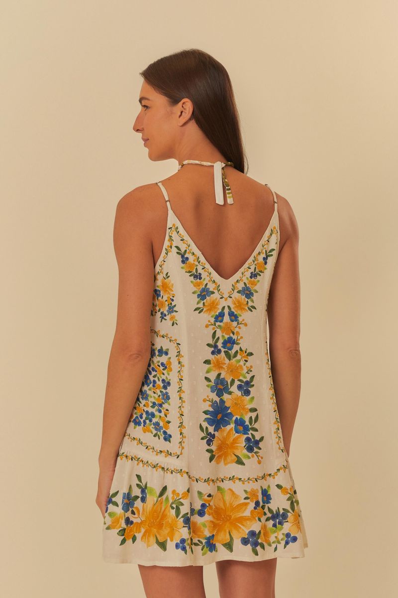 Vista lateral del vestido corto floral, mostrando el corte fluido y el estampado en toda la pieza.