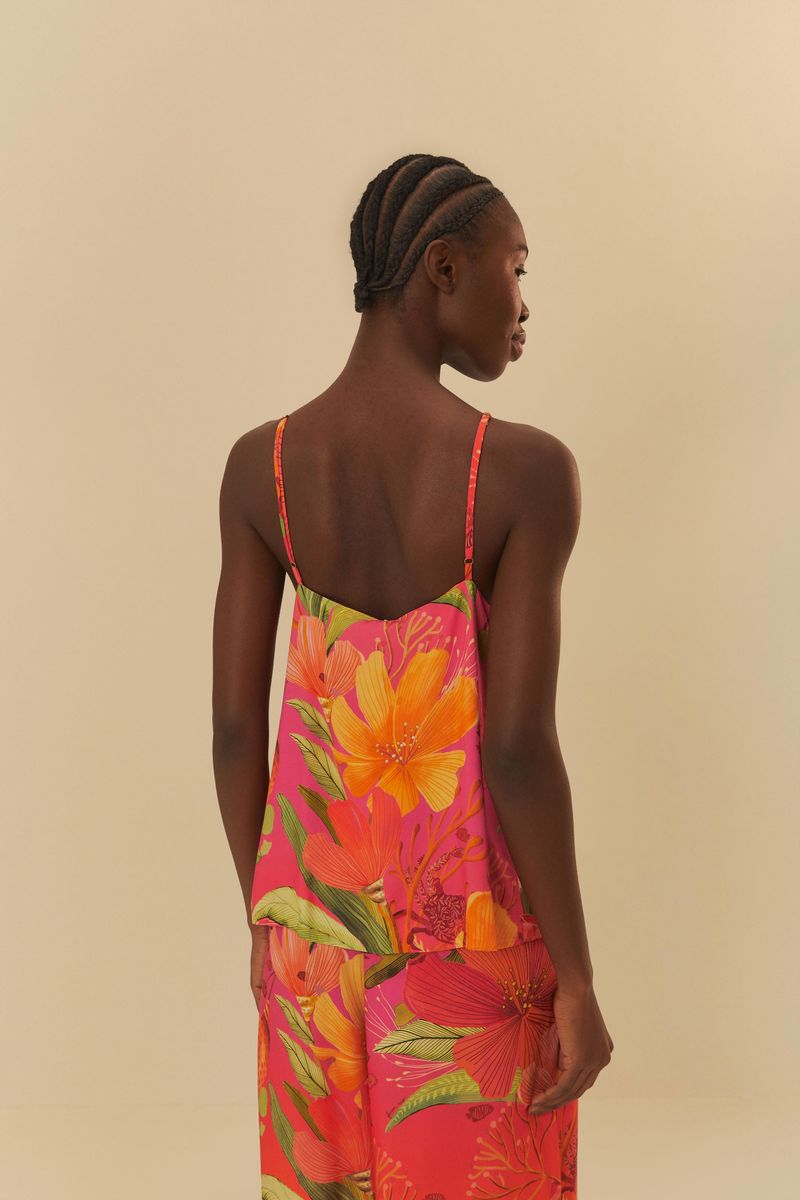 Vista trasera de la blusa mostrando tirantes delgados y estampado floral vibrante.