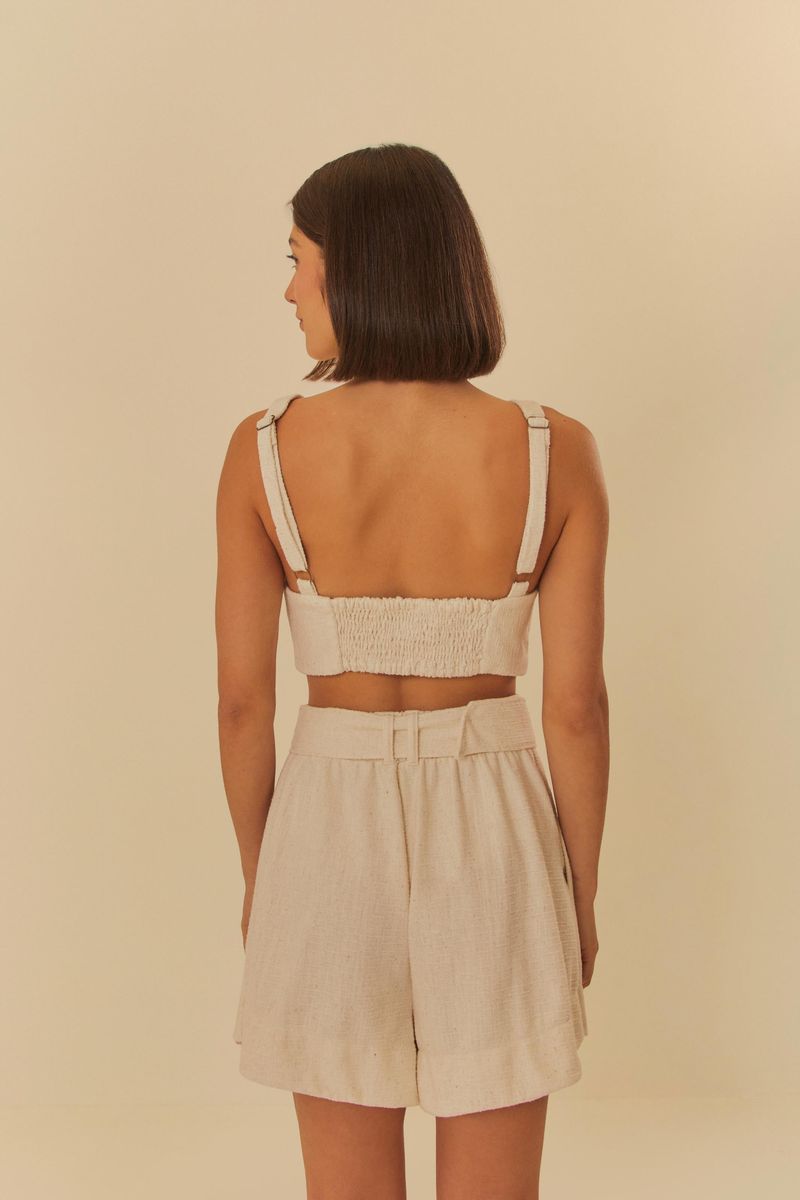 Modelo-de-espaldas-usando-short-de-tweed-beige-mostrando-el-ajuste-trasero.