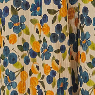 Primer-plano-del-estampado-floral-vibrante-en-tonos-de-azul-y-amarillo-sobre-fondo-beige.