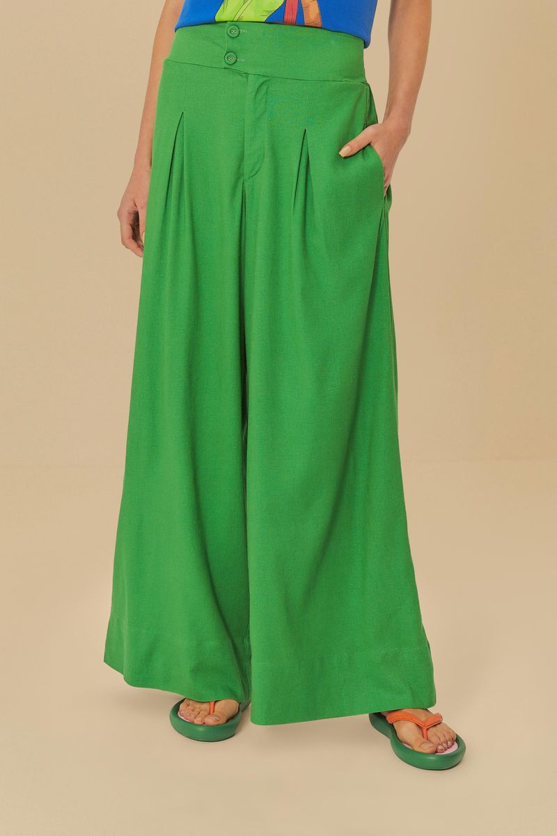 Detalle de la cinturilla y cierre del pantalón verde.