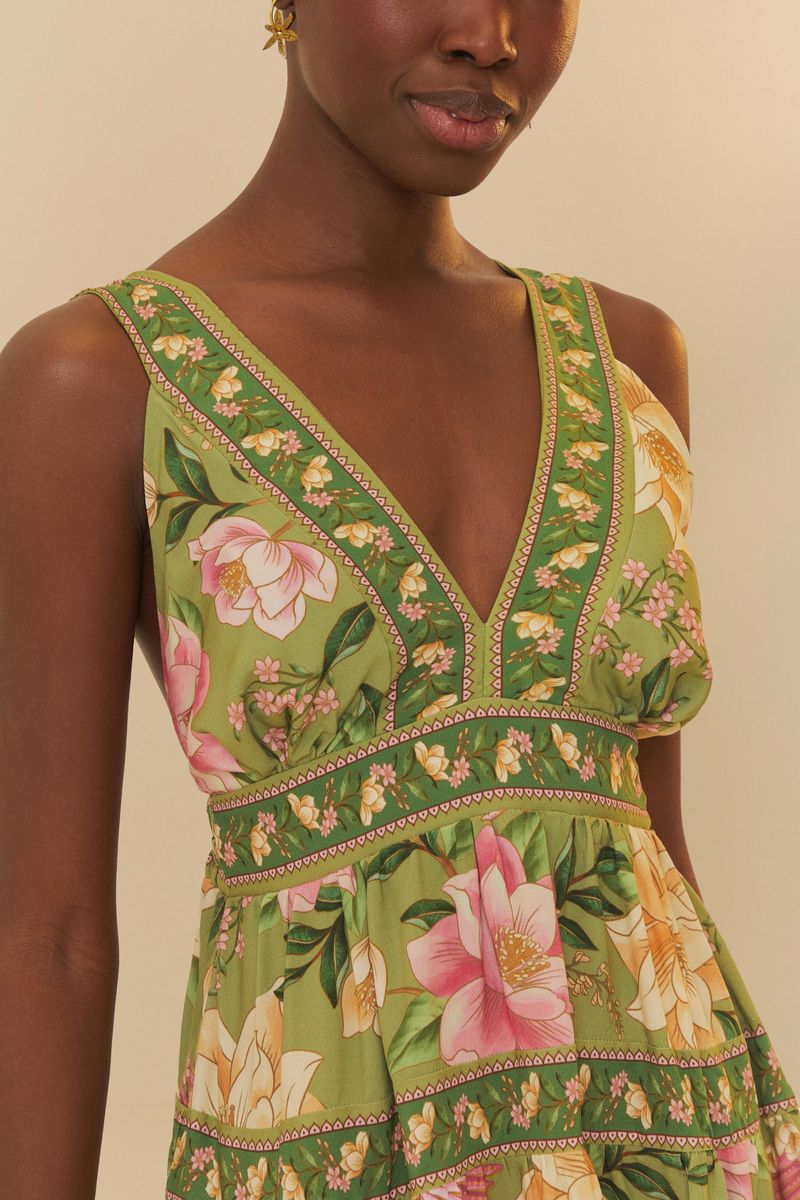 Detalle del corsé del vestido mostrando el escote en V y el estampado floral con elementos tropicales.