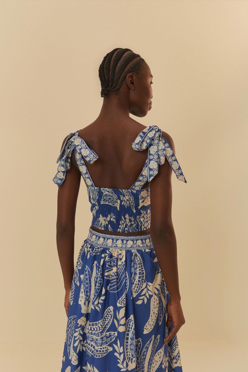 Blusa estampada con bananos y encaje, vista trasera destacando los detalles de los tirantes.