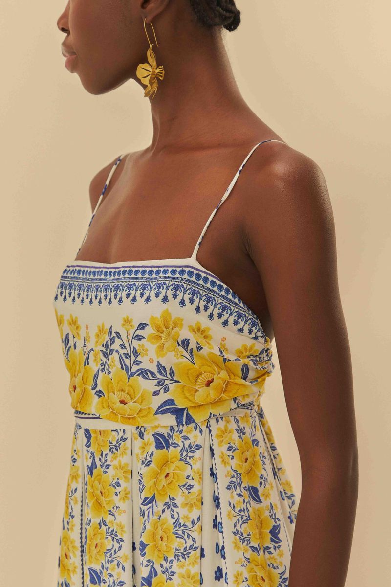 Detalle del vestido largo estampado mostrando el diseño floral amarillo y azul en el área del busto.