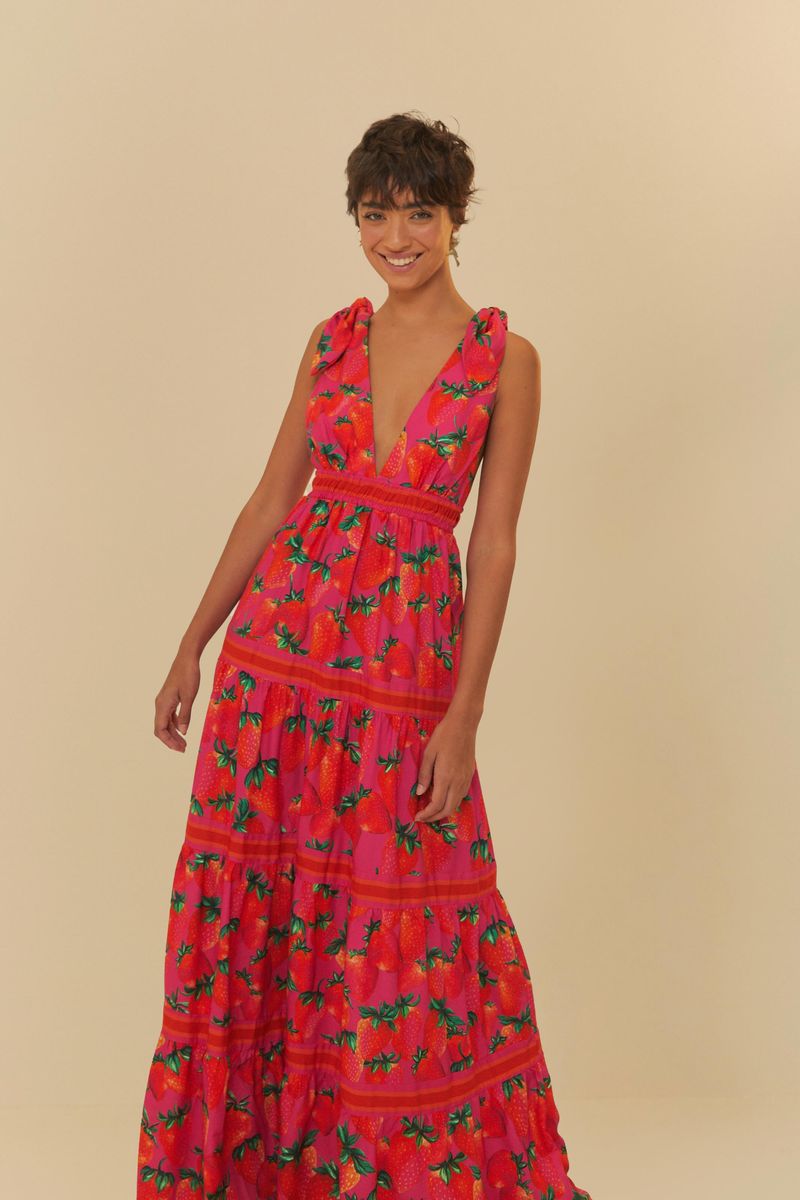 Vestido largo estampado con fondo rosado y detalles de fresas, escote en V profundo y tirantes anchos.