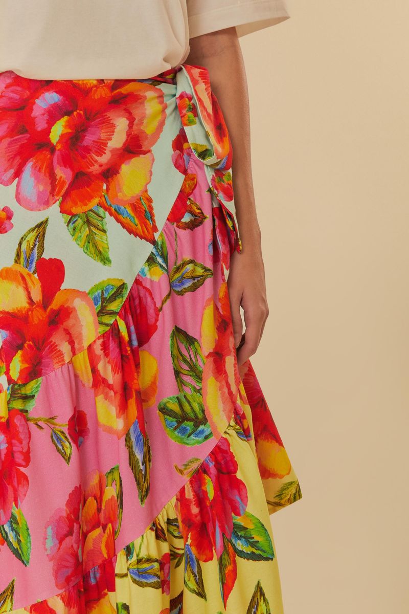 Vista lateral de la falda floral, destacando la caída de la tela y la combinación con accesorios.