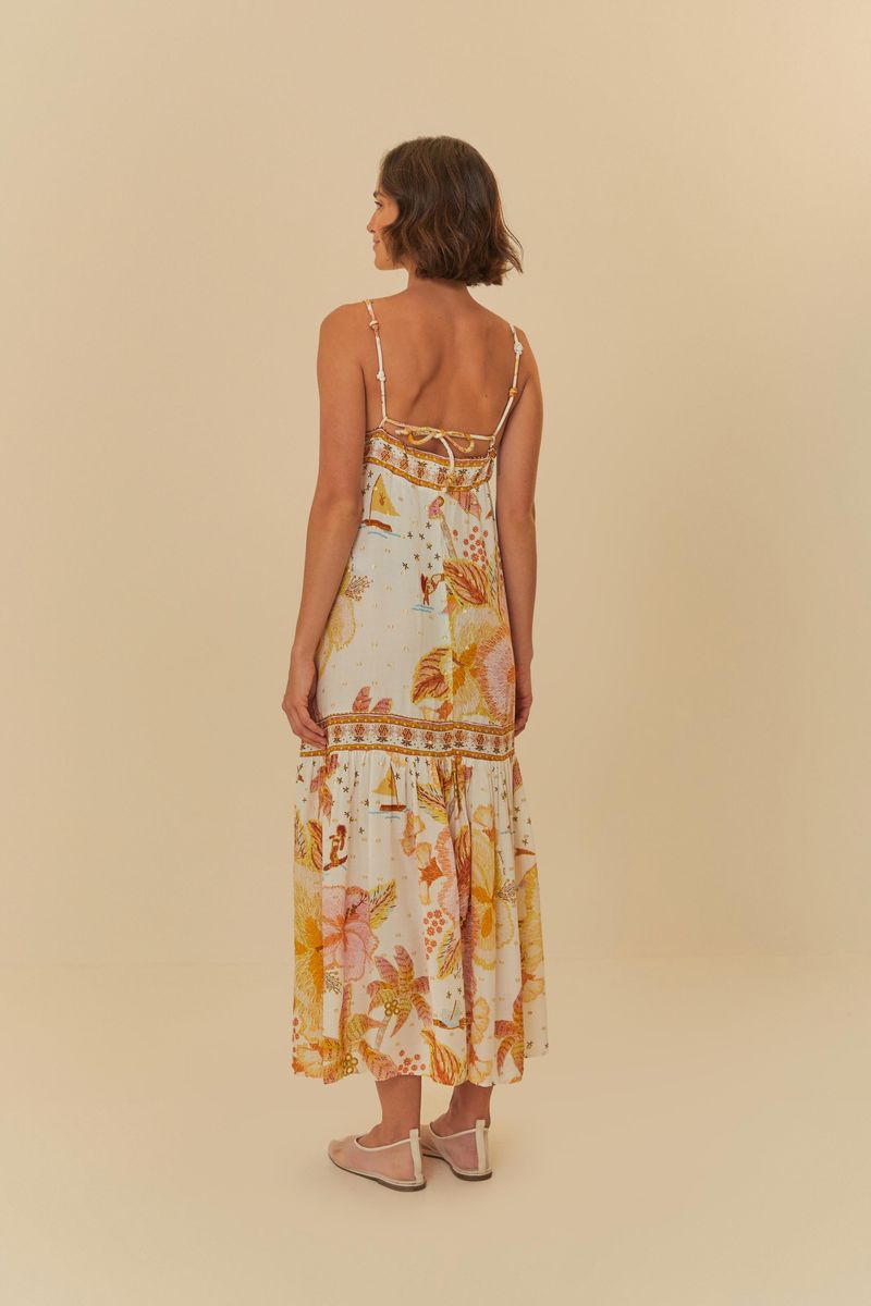 Vista trasera del vestido estampado, mostrando tirantes finos y diseño floral.