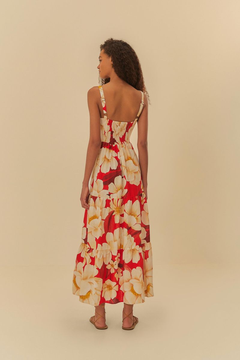 Vista trasera del vestido largo estampado con tiras finas, mostrando el diseño floral y la caída.