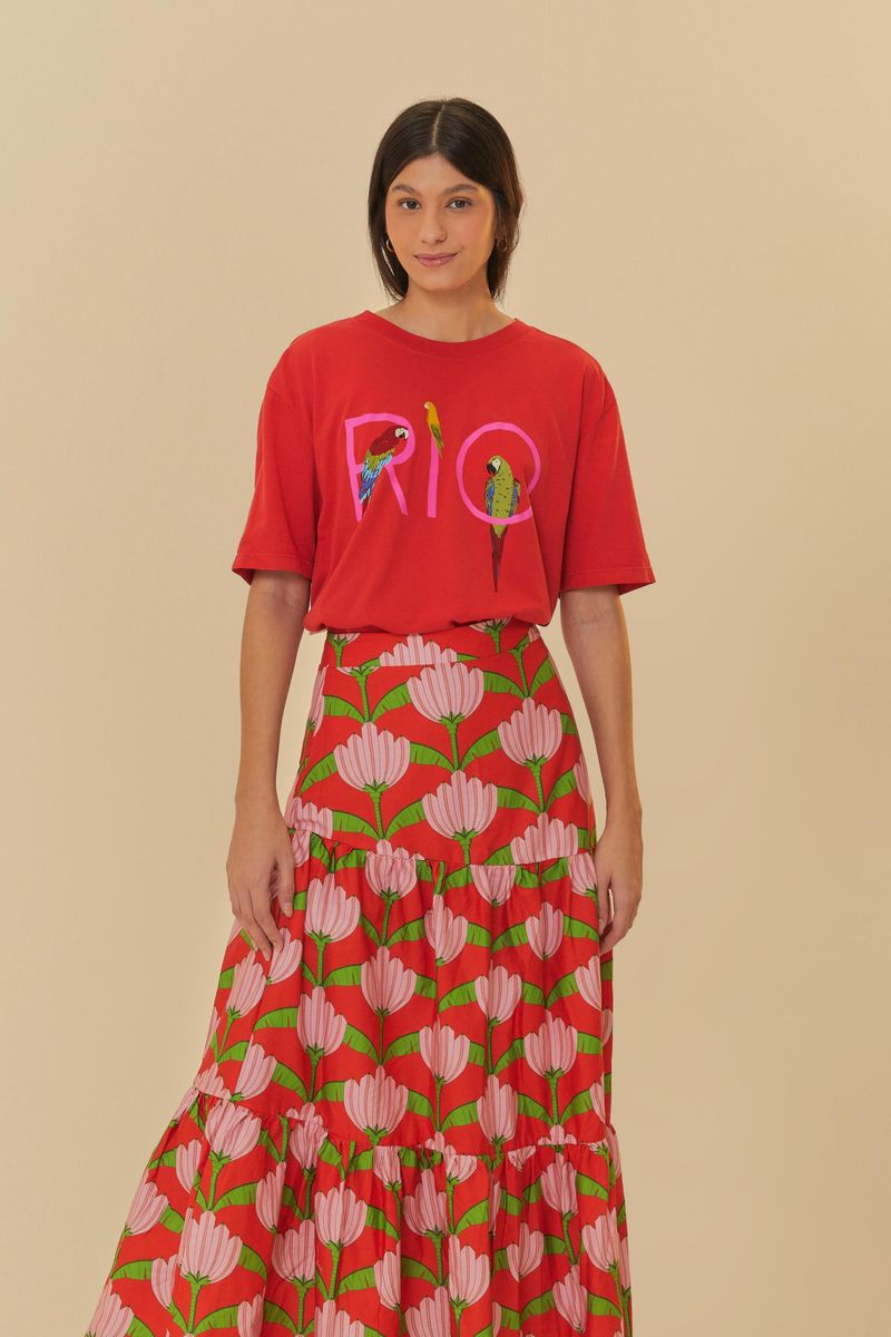 Vista posterior de la falda larga estampada con volantes y camiseta roja con la palabra 'RIO' estampada.