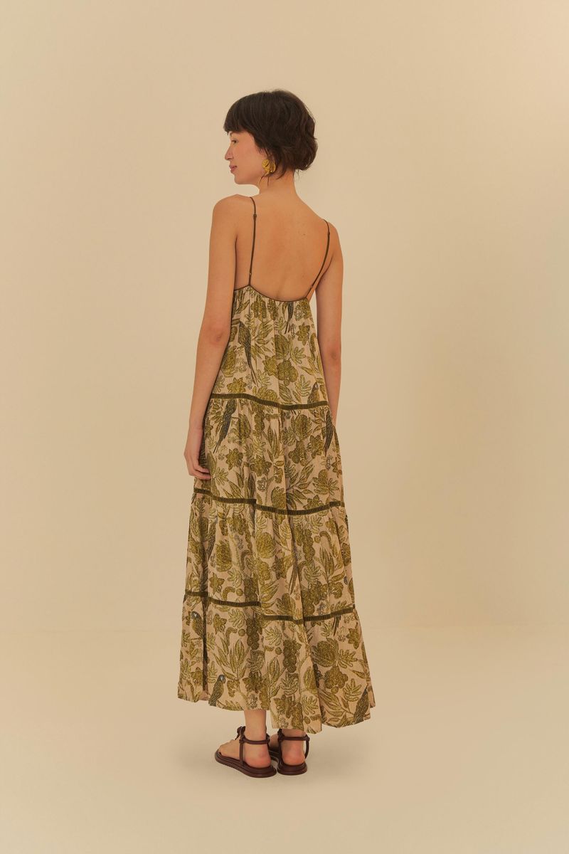 Imagen de un vestido largo con estampado floral en tonos de verde y beige, mostrando detalles del dobladillo.