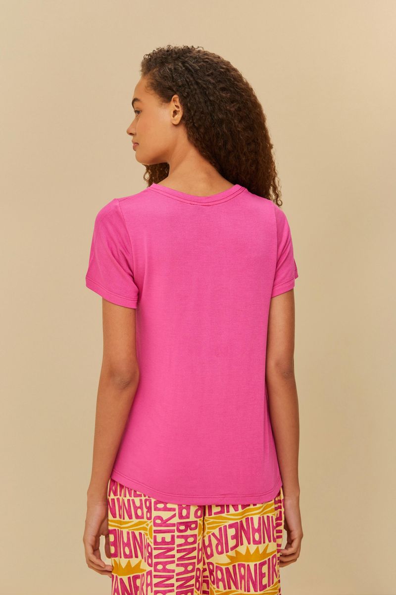 Camiseta básica rosa vibrante vista de espaldas, con borde recto.