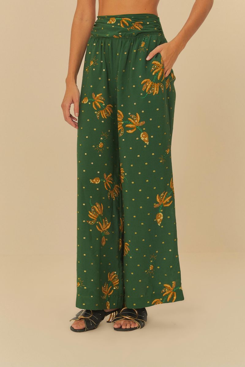 Imagen de una falda larga estampada con fondo verde y detalles amarillos, vista trasera.