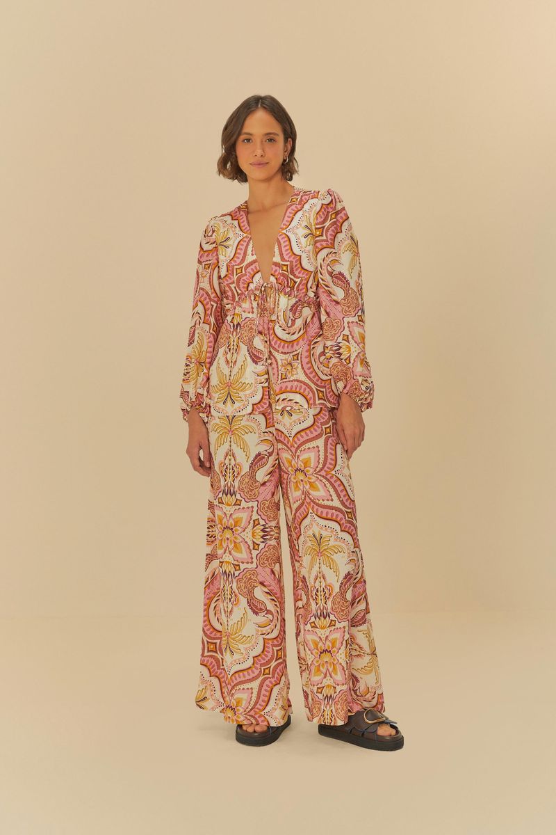 Imagen de una blusa estampada con motivo tropical, vista completa con pantalón combinado.