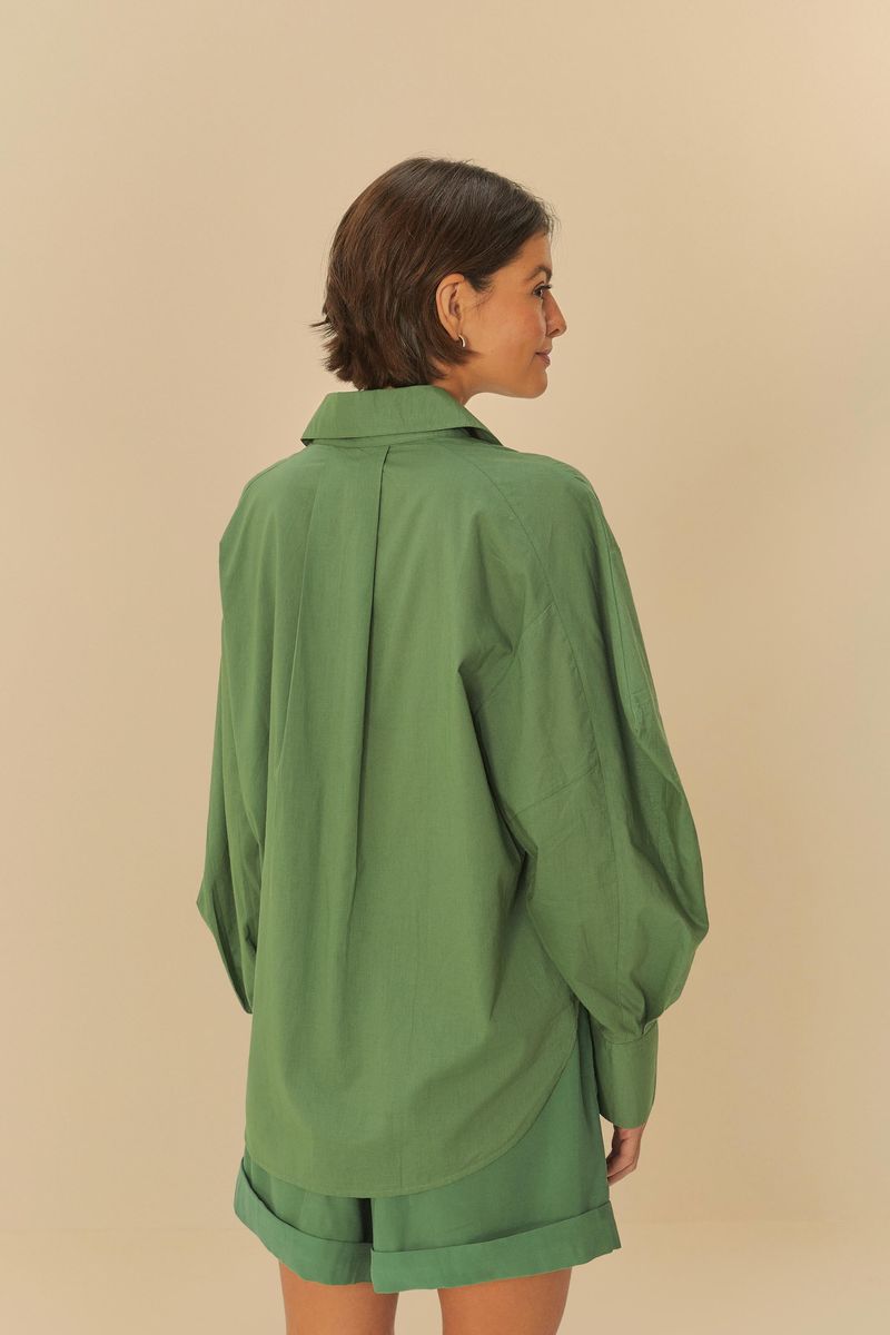 Vista trasera de la camisa básica de algodón verde con borde redondeado.