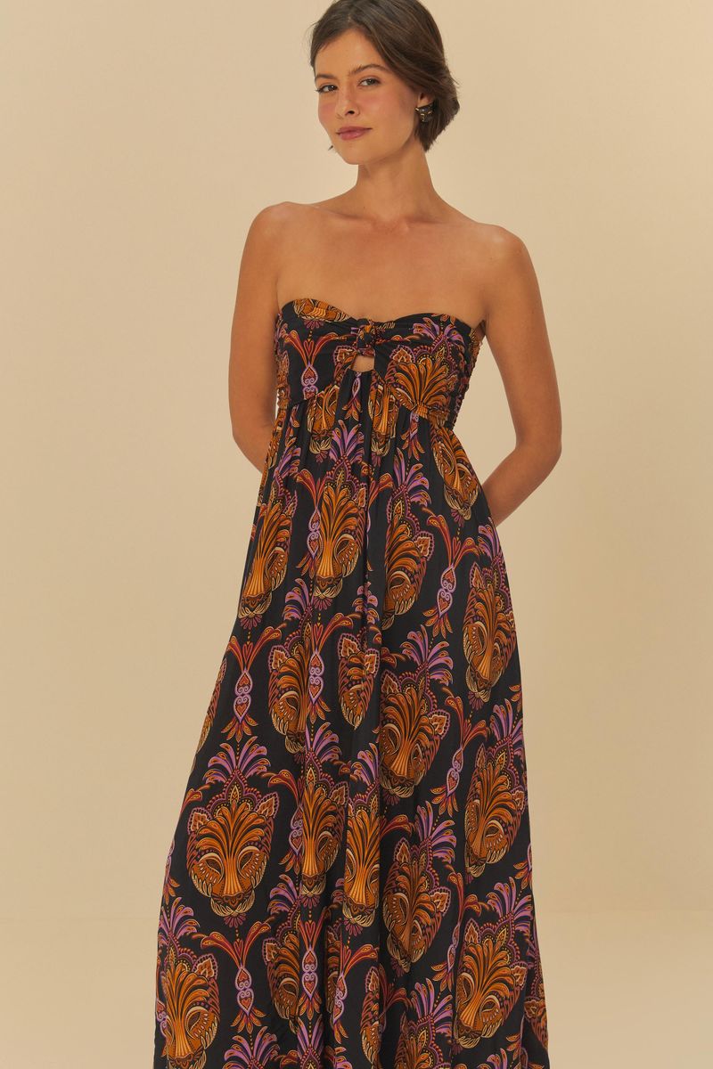 Imagen mostrando un vestido largo estampado con patrón boho, con detalles en naranja y morado sobre fondo negro, visto de frente.