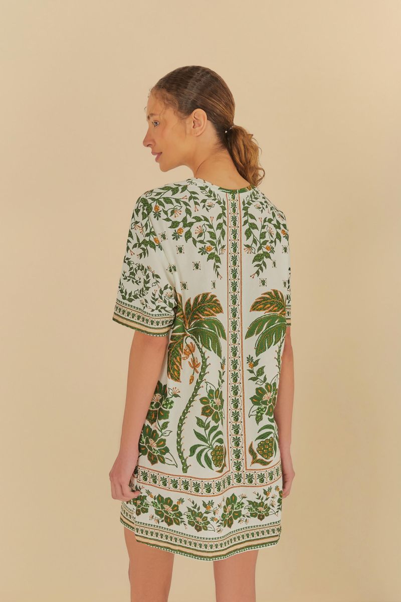 Vista trasera del vestido estilo camiseta con estampado botánico, mostrando el diseño completo.