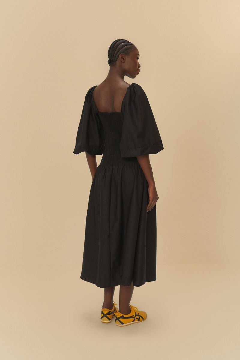 Vista trasera del vestido cropped negro con mangas largas.