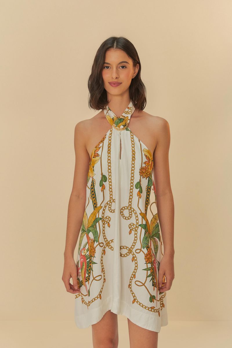Vestido corto con estampado tropical, tipo halter y cuello alto.