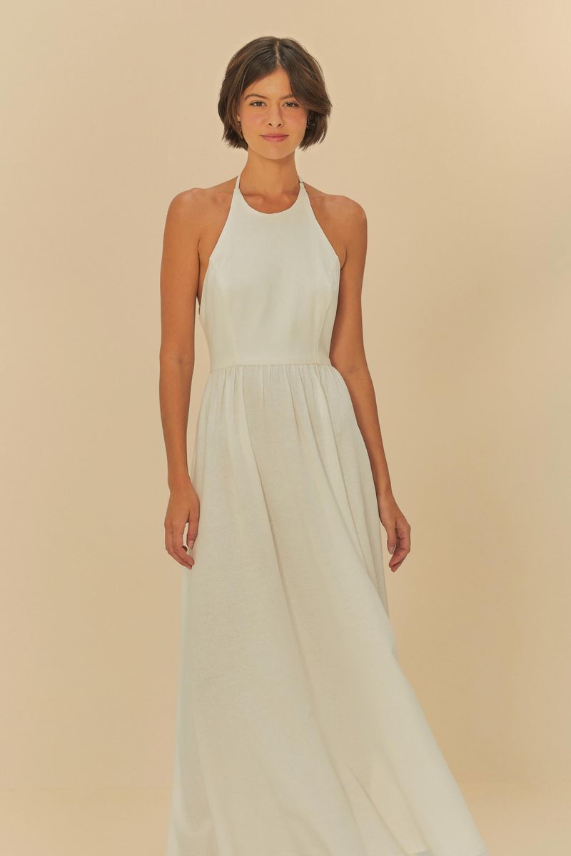 Imagen que muestra un vestido de cuello halter largo en tono claro, con ajuste en la cintura y caída fluida.