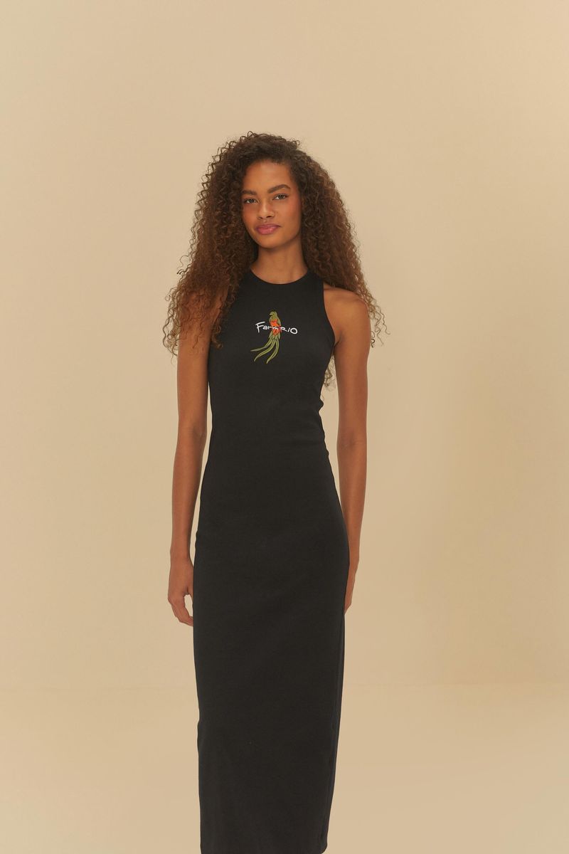 Vista trasera del vestido negro cropped con estampado de pimientos y logotipo Farm Rio, mostrando el detalle de la abertura.
