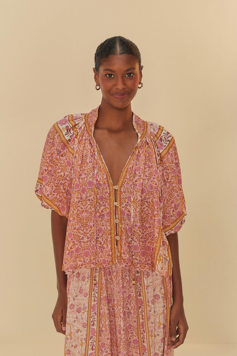 Imagen-de-una-blusa-estampada-con-detalles-florales-en-tonos-de-rosa-y-amarillo-vista-de-frente.