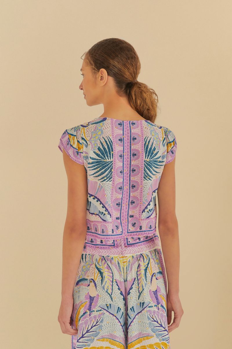 Vista trasera de la Blusa Tapete de Tucano con estampado tropical y detalles vibrantes.