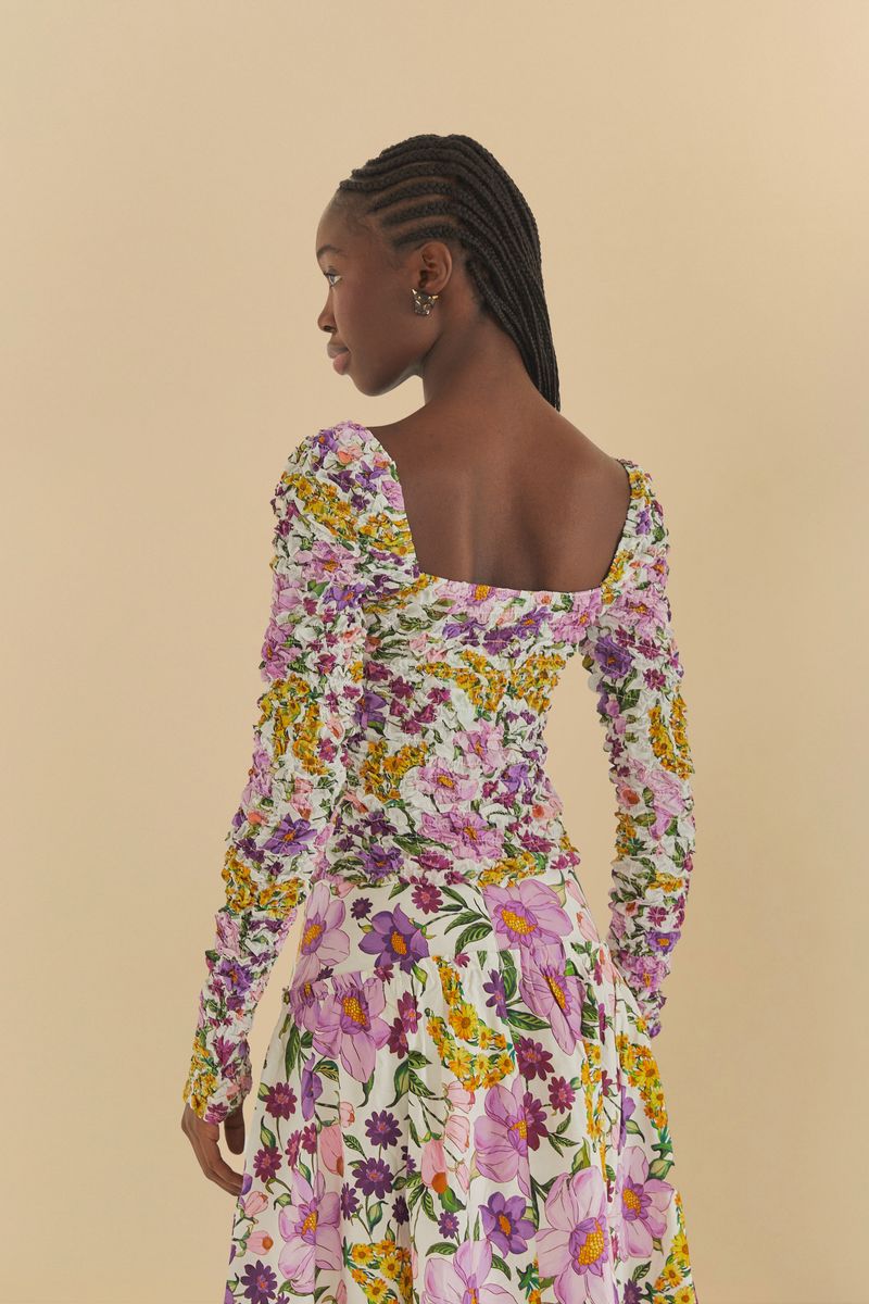 Vista trasera de la Blusa Banana Flor destacando el escote y el estampado.