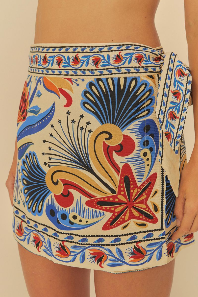 Detalle del lateral de la falda cruzada con estampado tropical.