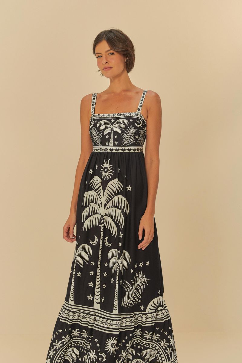 Vestido midi estampado con palmeras y elementos tropicales, visto de frente.