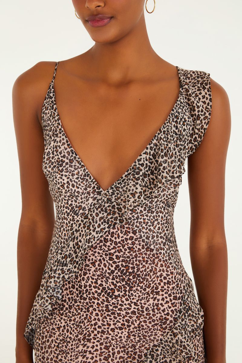Primer plano del escote en V del vestido con estampado de leopardo y volantes.