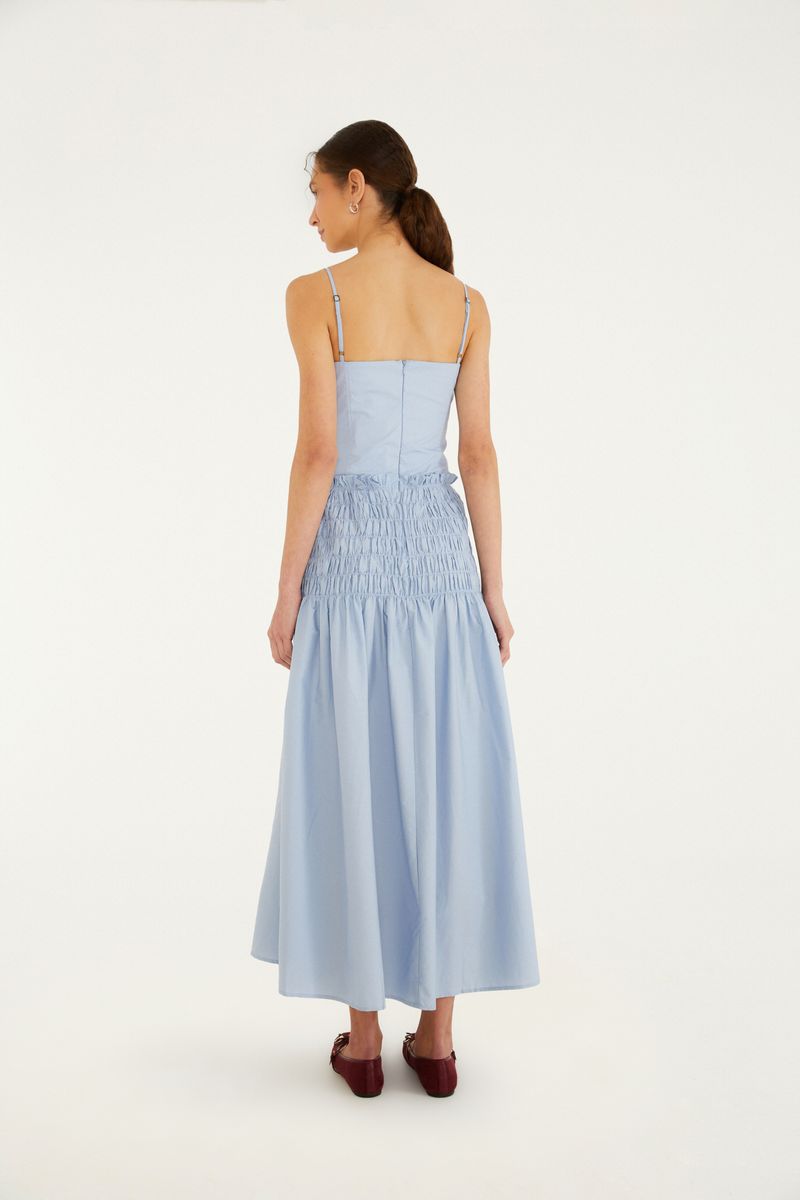 Detalle de la falda del vestido azul claro con acabado en fruncido en la cintura.