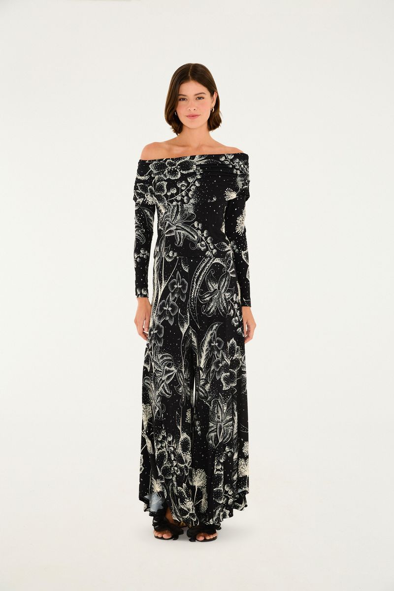 Imagen de un pantalón palazzo con estampado floral sobre fondo negro, vista frontal.
