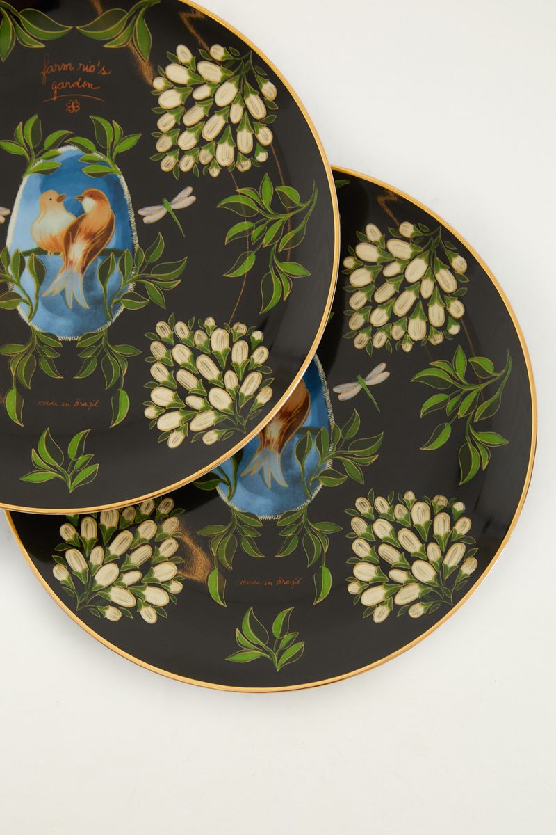 Detalle del diseño del plato llano Joy a La Carte Pájaro con pájaro y elementos botánicos.