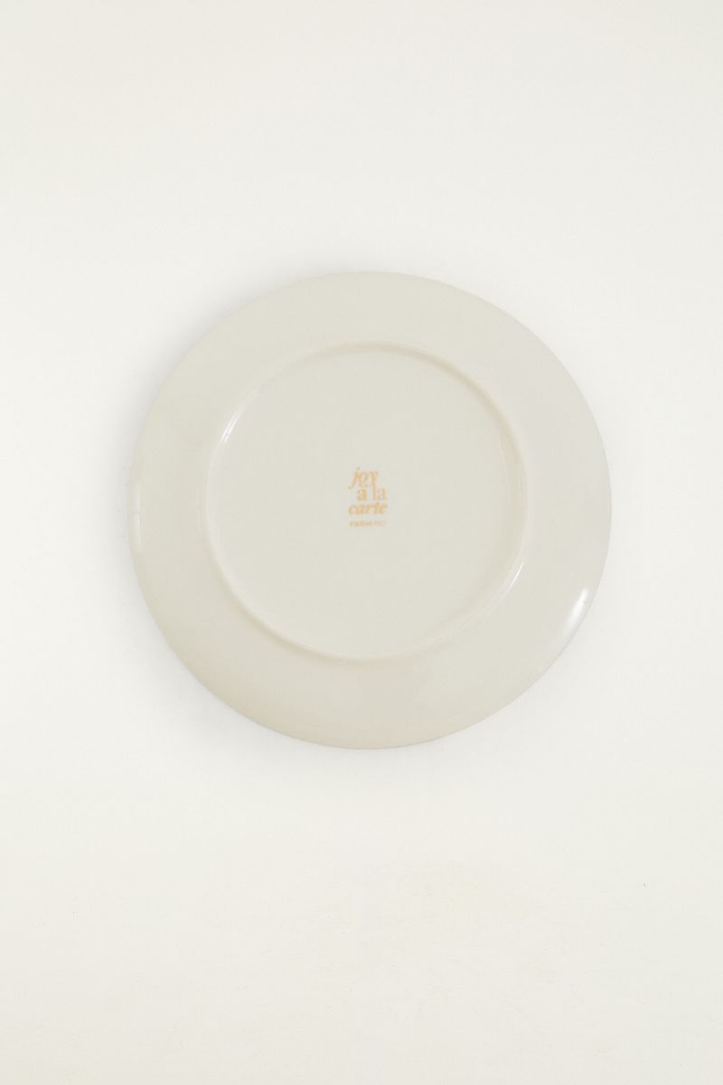 Vista trasera del plato llano Joy a La Carte Pájaro mostrando acabado blanco y logotipo de la marca.