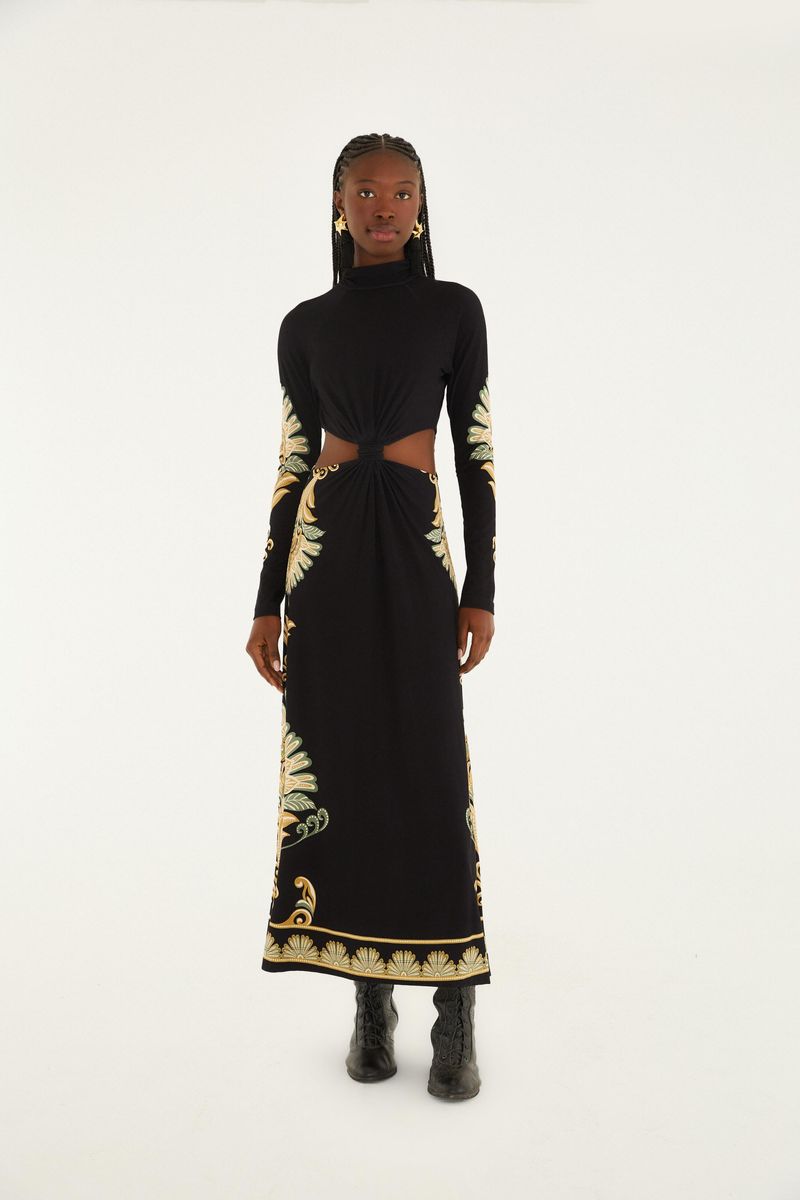 Vestido largo negro con detalles estampados en amarillo y verde, con recorte en la cintura y cuello alto.