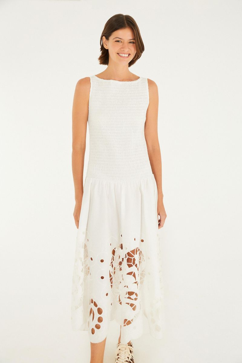 Vestido blanco con detalles bordados en forma de corazón en la parte inferior, visto de espaldas.
