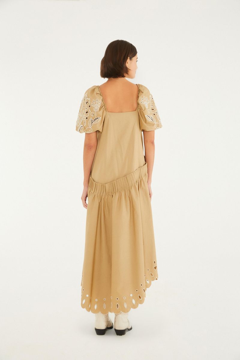 Vestido beige con bordado Richelieu, manga abullonada y longitud larga, visto de espaldas.