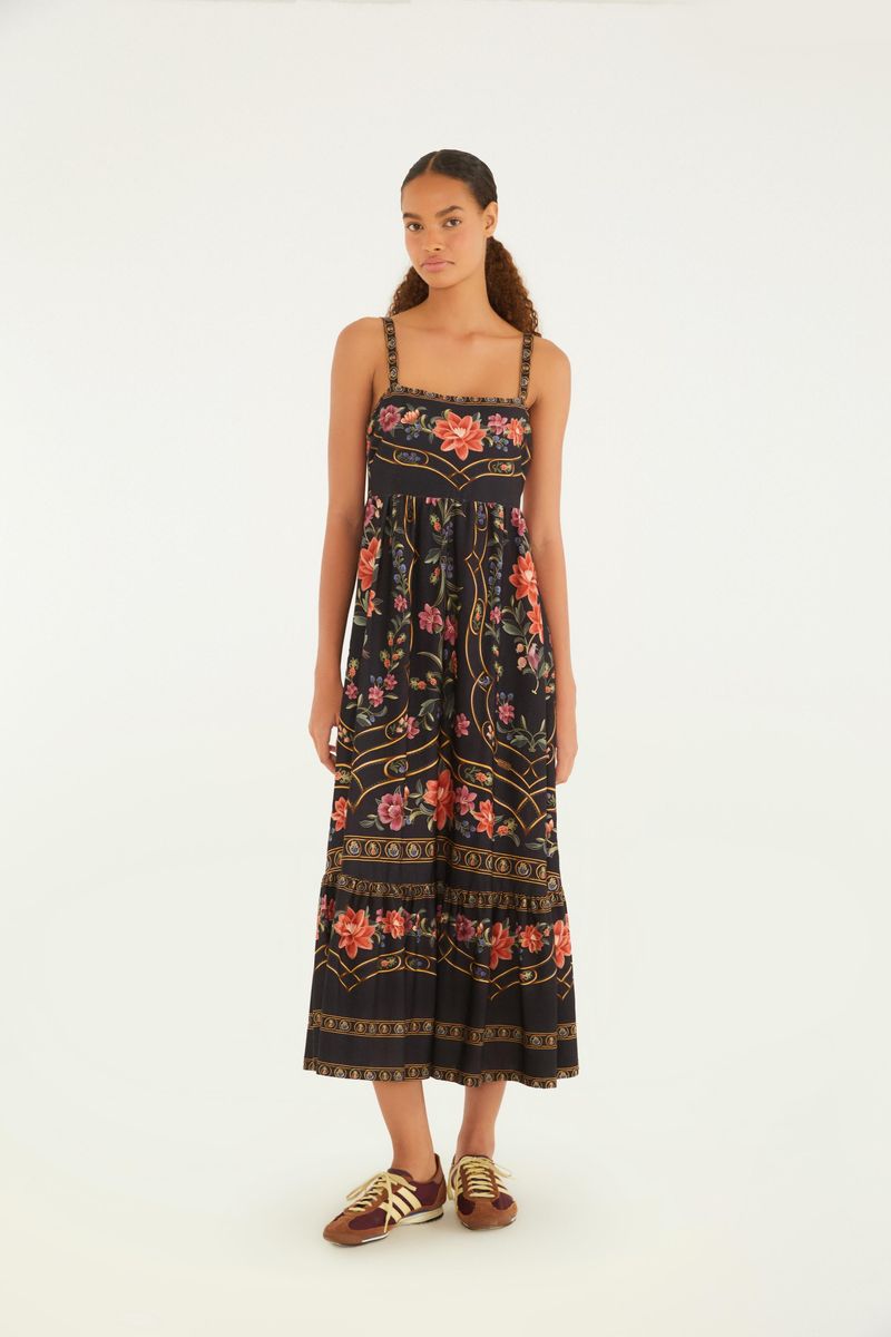 Vestido midi floral Belle visto de frente, con tirantes decorados y estampado floral vibrante sobre un fondo oscuro.